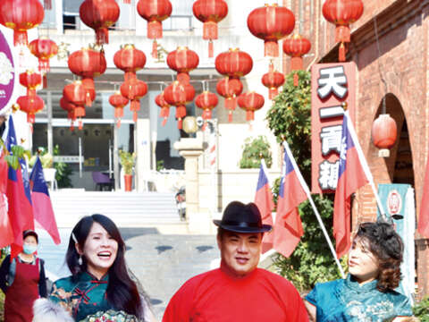 金城鎮模範街懸掛起紅色的燈籠。穿上民國初年的服裝在早年的洋樓建築間拍照，饒富趣味，金城鎮長李誠智邀請民眾也體驗「穿越」的妙趣。（詹宗翰攝）